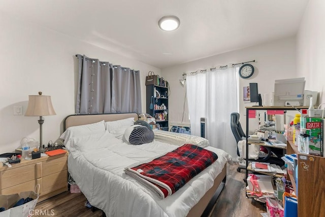 bedroom with dark hardwood / wood-style floors