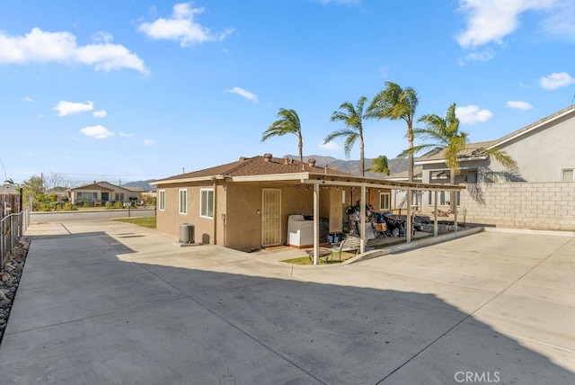 rear view of property with washer / dryer and a patio area