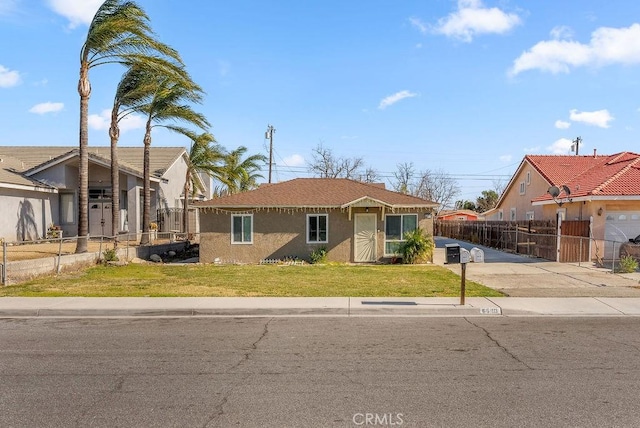 view of front of home featuring a garage and a front lawn