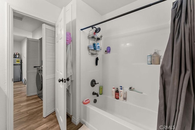 bathroom featuring shower / bath combination with curtain and hardwood / wood-style flooring