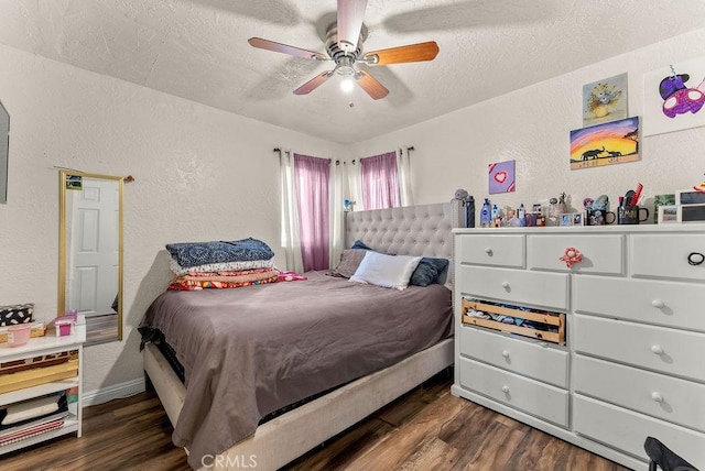 bedroom with ceiling fan, dark hardwood / wood-style flooring, and a textured ceiling