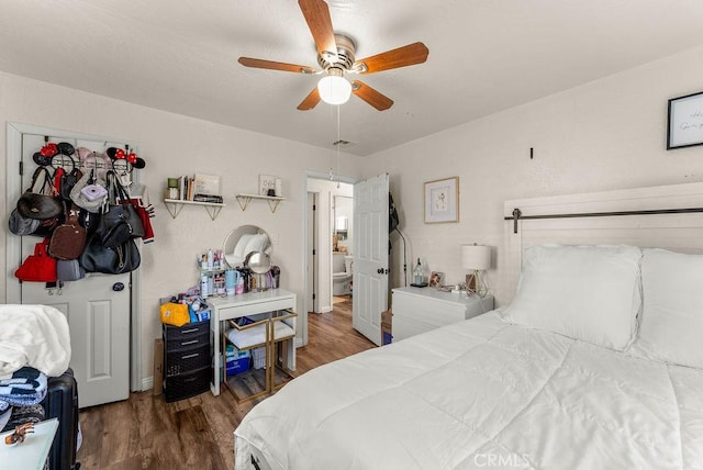 bedroom with ceiling fan and dark wood-type flooring