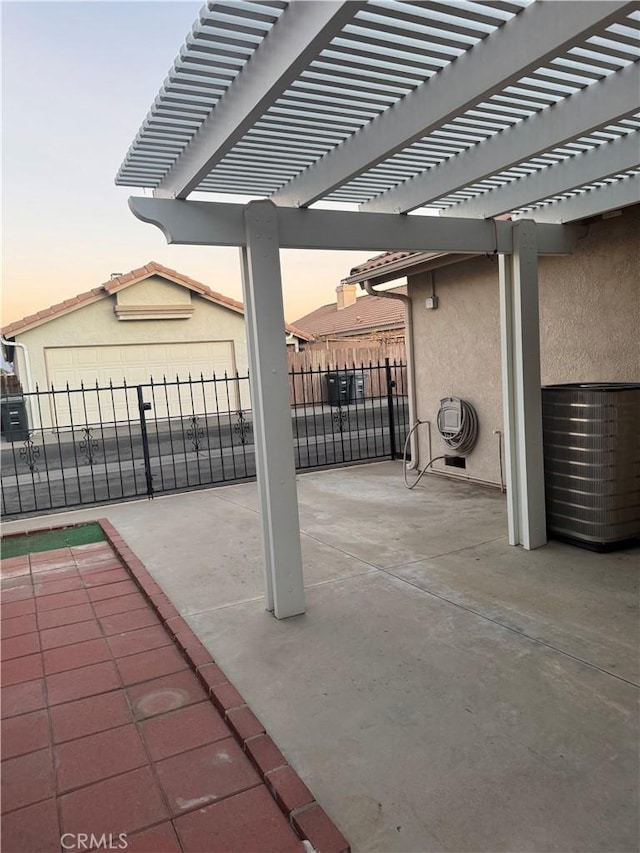 patio terrace at dusk featuring a pergola