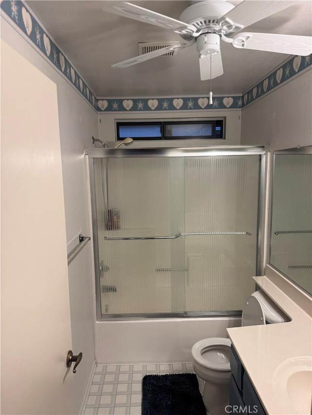 full bathroom with toilet, bath / shower combo with glass door, vanity, and ceiling fan