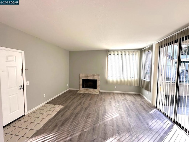 unfurnished living room featuring hardwood / wood-style floors and a fireplace