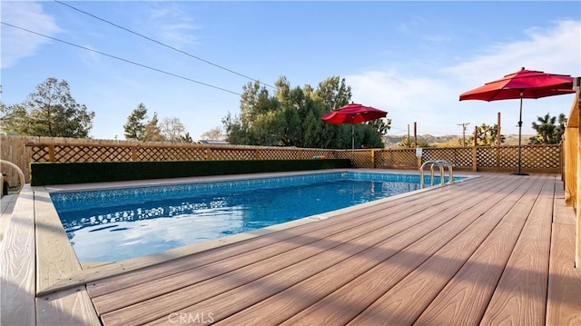 view of swimming pool featuring a wooden deck