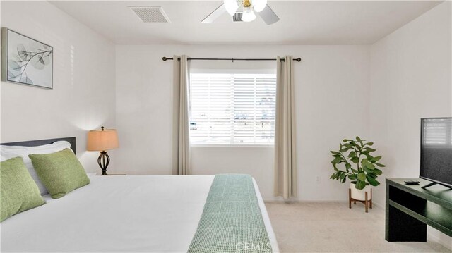 bedroom with ceiling fan and light colored carpet