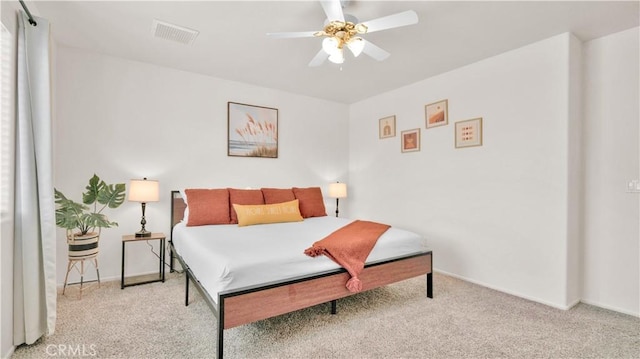 bedroom with ceiling fan and light carpet