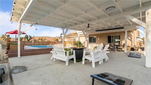 view of patio featuring a fenced in pool and ceiling fan