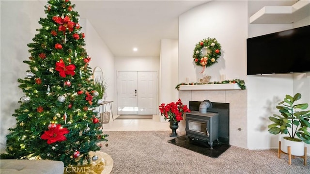 carpeted living room with a wood stove