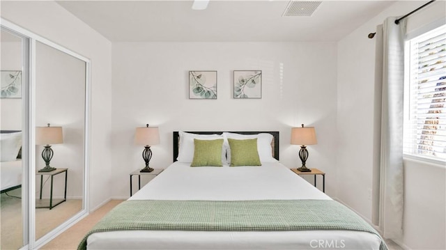 bedroom with ceiling fan and multiple windows