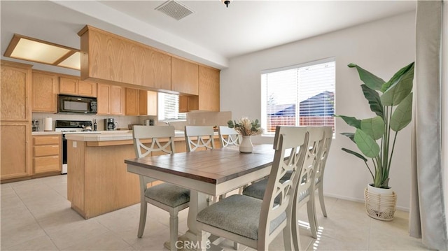 dining space featuring light tile patterned floors