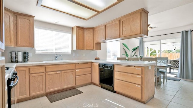 kitchen with dishwasher, decorative backsplash, sink, kitchen peninsula, and gas range oven