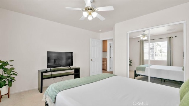 carpeted bedroom featuring ceiling fan and a closet