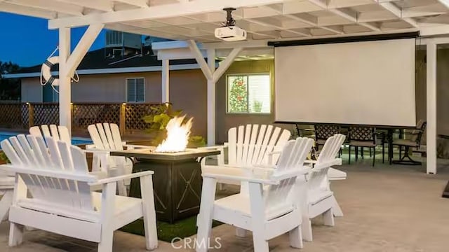 exterior space featuring ceiling fan and an outdoor fire pit