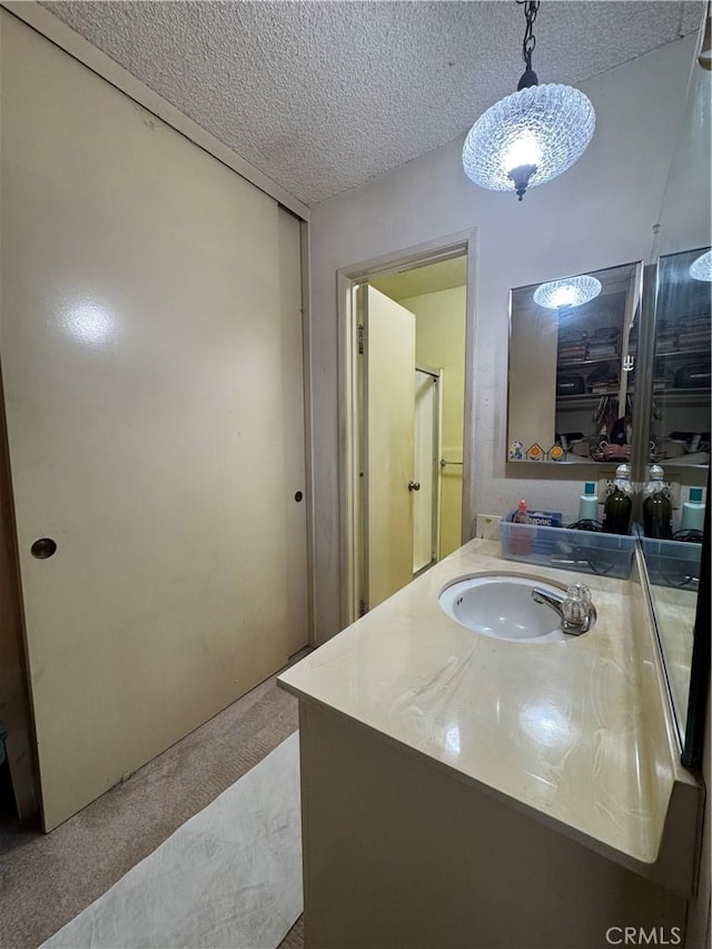 bathroom featuring vanity and a textured ceiling