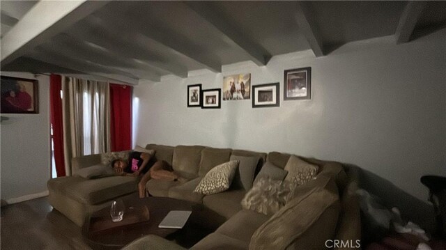 living room featuring beam ceiling