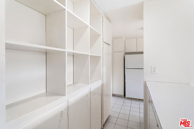 walk in closet featuring light tile patterned flooring