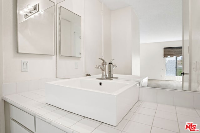 bathroom featuring tile patterned floors and vanity