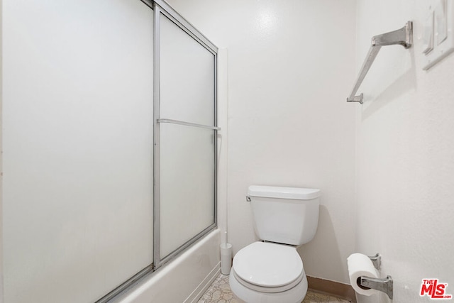 bathroom with enclosed tub / shower combo and toilet