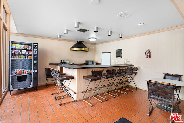 bar with crown molding and refrigerator