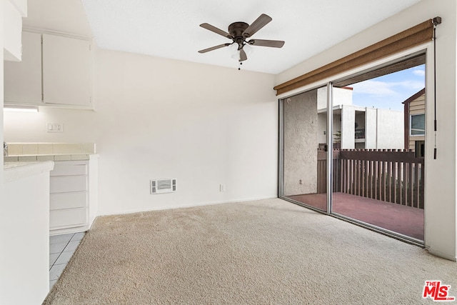 unfurnished living room with ceiling fan and light carpet