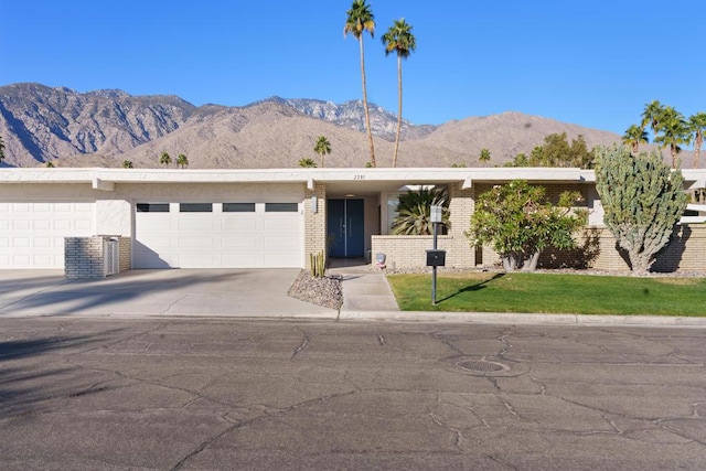 ranch-style house with a garage, central air condition unit, and a mountain view