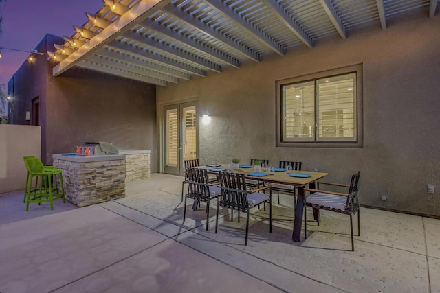 view of patio / terrace featuring exterior kitchen, an outdoor bar, and a pergola