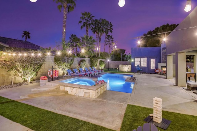 view of swimming pool featuring a patio and an in ground hot tub