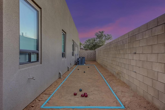 property exterior at dusk featuring central AC