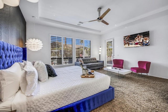 bedroom featuring ceiling fan and a tray ceiling