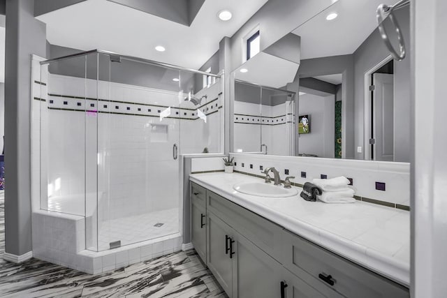 bathroom with a shower with door and vanity