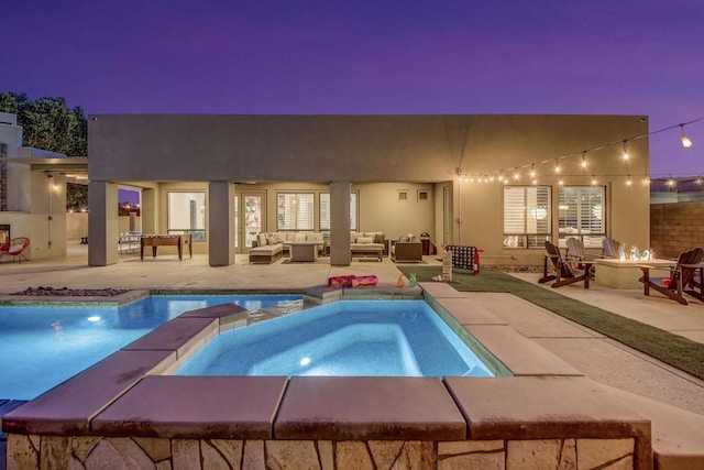 view of swimming pool with an outdoor living space with a fire pit, a patio, and an in ground hot tub