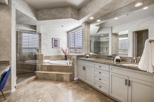 bathroom featuring shower with separate bathtub and vanity