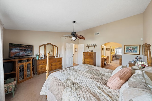 bedroom featuring ceiling fan, light carpet, and vaulted ceiling