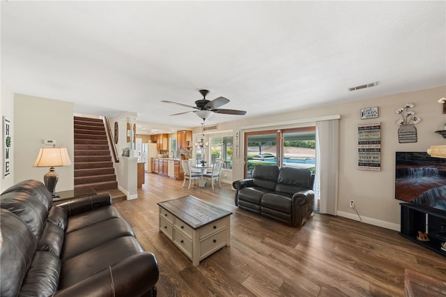 living room with ceiling fan and hardwood / wood-style floors