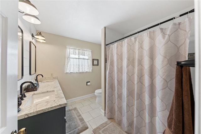 bathroom featuring toilet, vanity, tile patterned flooring, and walk in shower