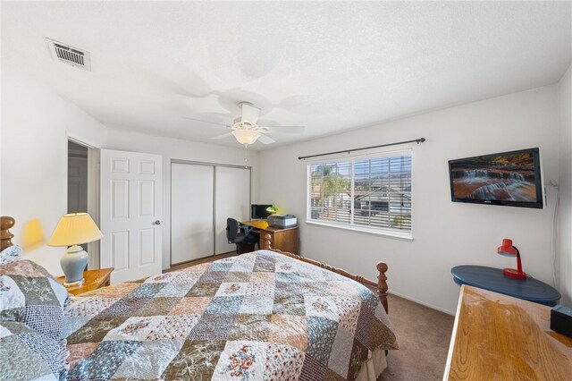 bedroom featuring ceiling fan, a closet, and carpet floors