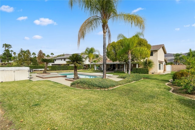 view of yard featuring a fenced in pool and a patio