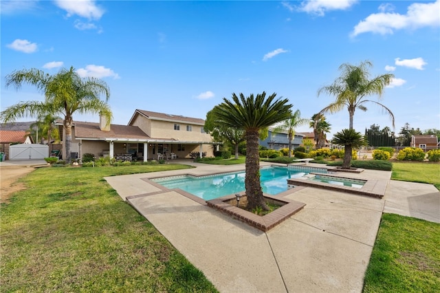 view of pool with a lawn, a patio area, and an in ground hot tub