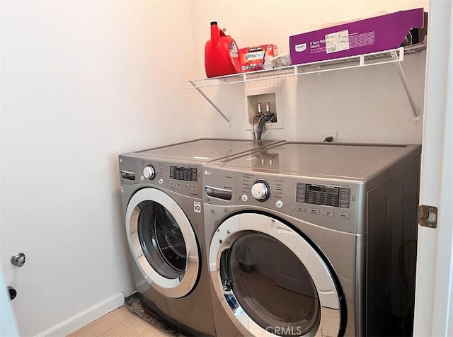 clothes washing area with washing machine and clothes dryer