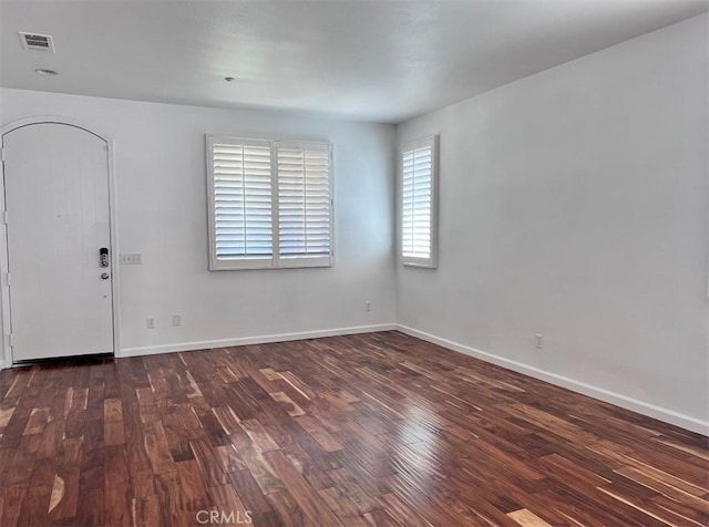 unfurnished room featuring dark hardwood / wood-style floors