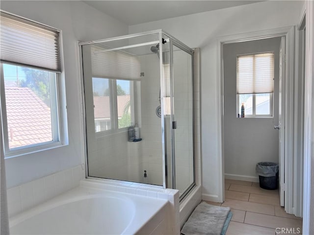 bathroom with separate shower and tub, tile patterned flooring, and a wealth of natural light