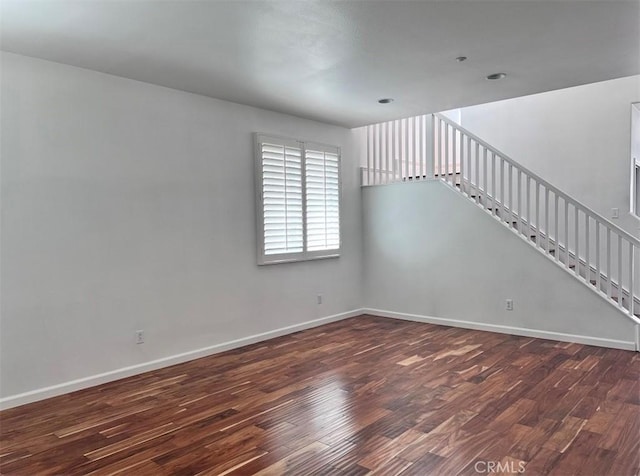 spare room with dark wood-type flooring