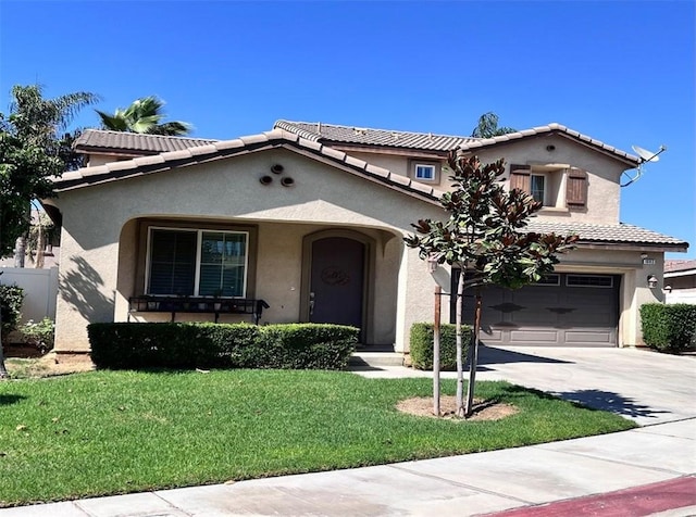 mediterranean / spanish home with a front yard and a garage