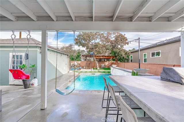 view of pool featuring an outdoor bar and a patio