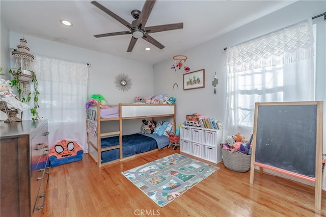 bedroom with ceiling fan and hardwood / wood-style flooring