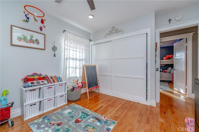 recreation room with wood-type flooring