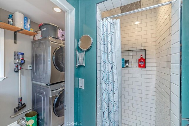 clothes washing area with stacked washer / dryer