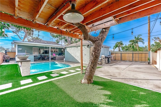 view of swimming pool featuring an outdoor structure, a lawn, and a patio